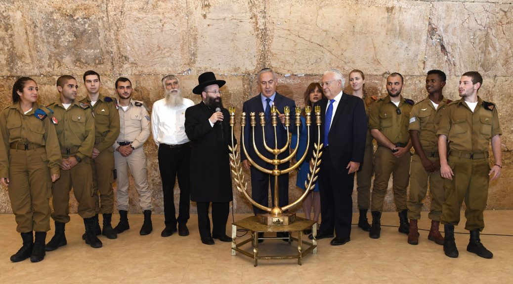 Illustrative photo from Chanukah lighting ceremony at Jerusalem's Western Wall with Israeli Prime Minister Netanyahu, U.S. Amb. Friedman and flanked by IDF soldiers. Photo Credit: U.S. Embassy Jerusalem / Matty Stern [License]